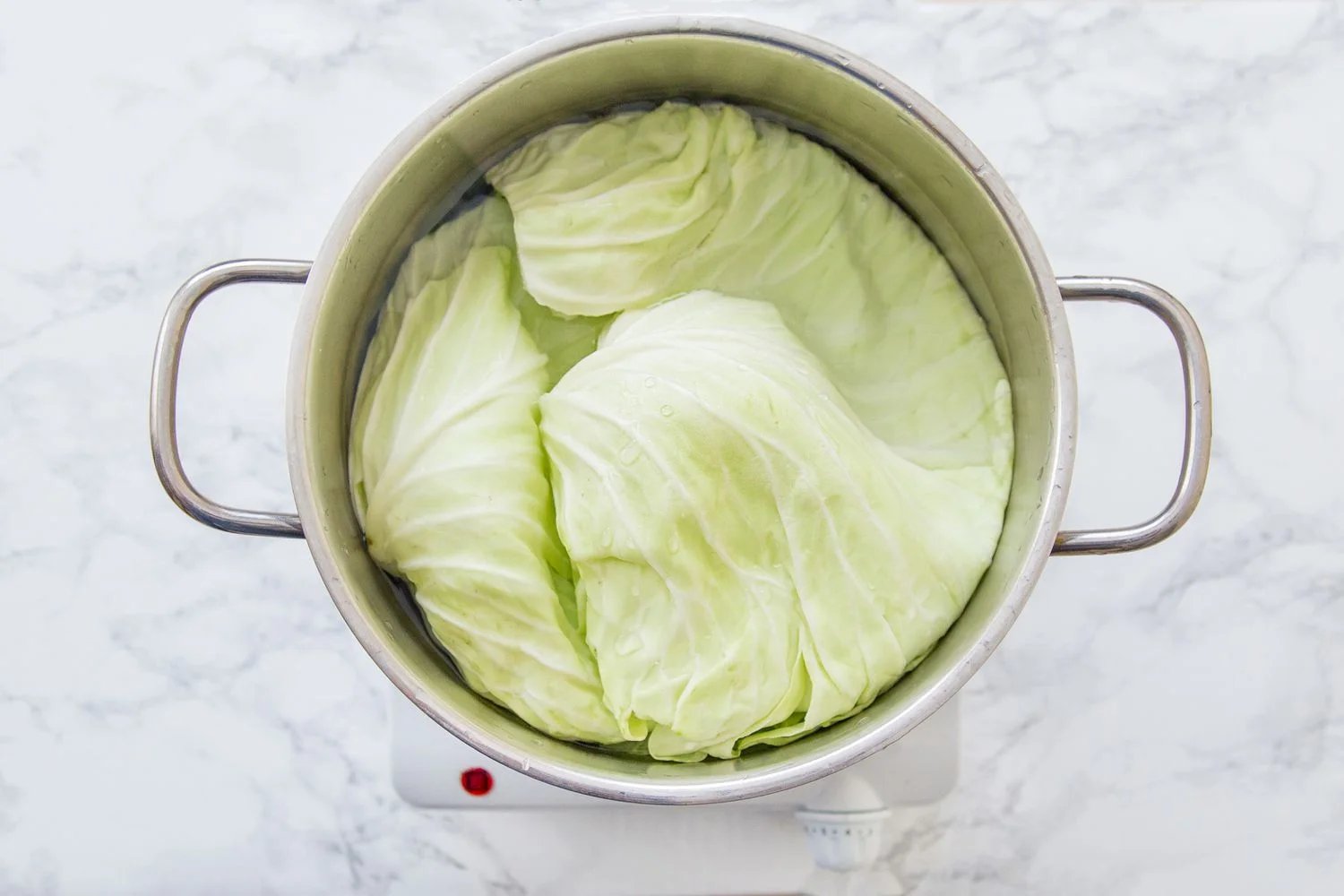 Cabbage leaves in a pot of salted water