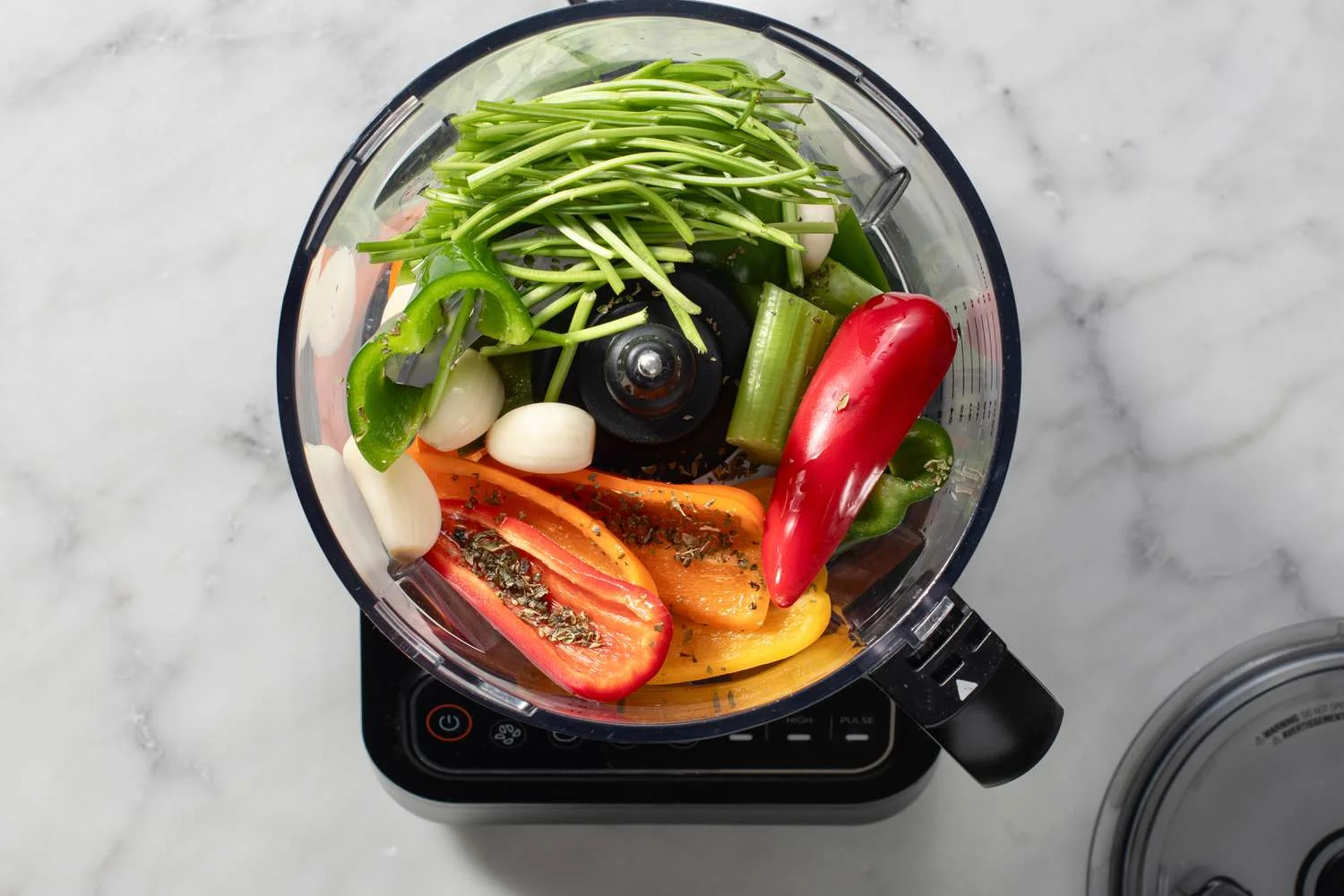 sofrito ingredients in bowl of food processor