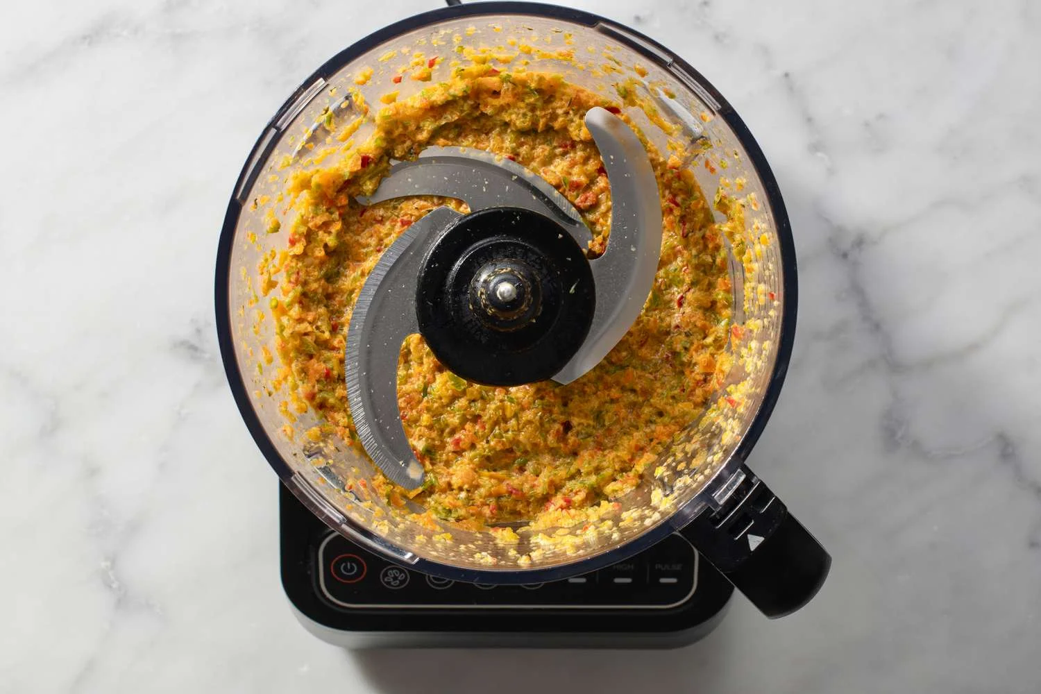 blended sofrito in bowl of food processor