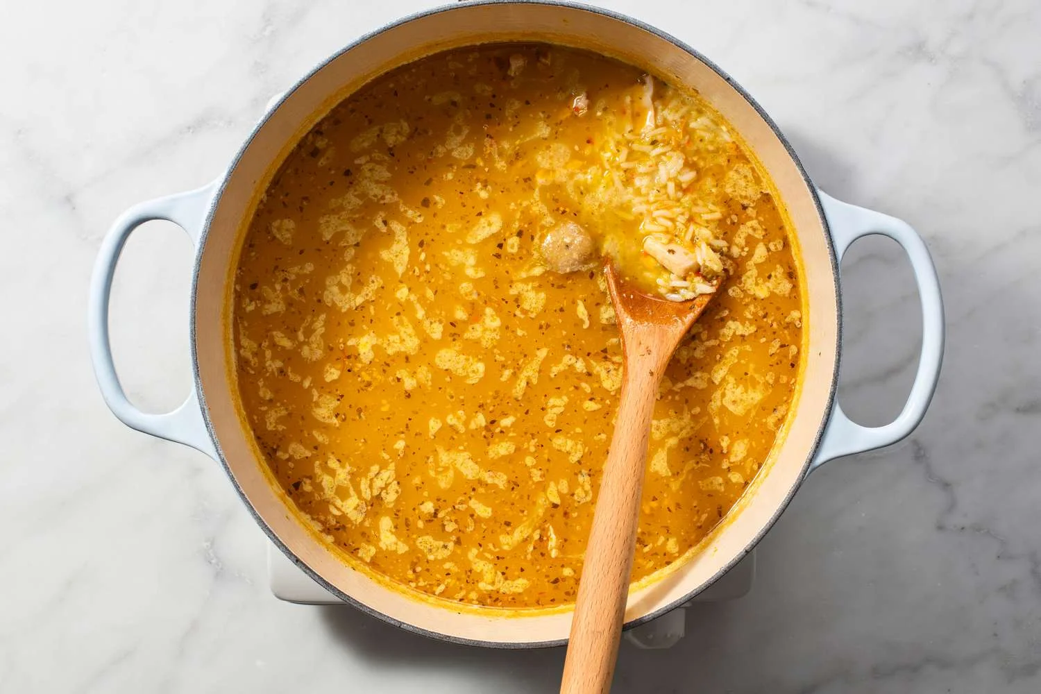rice added to pot of asopao de pollo 