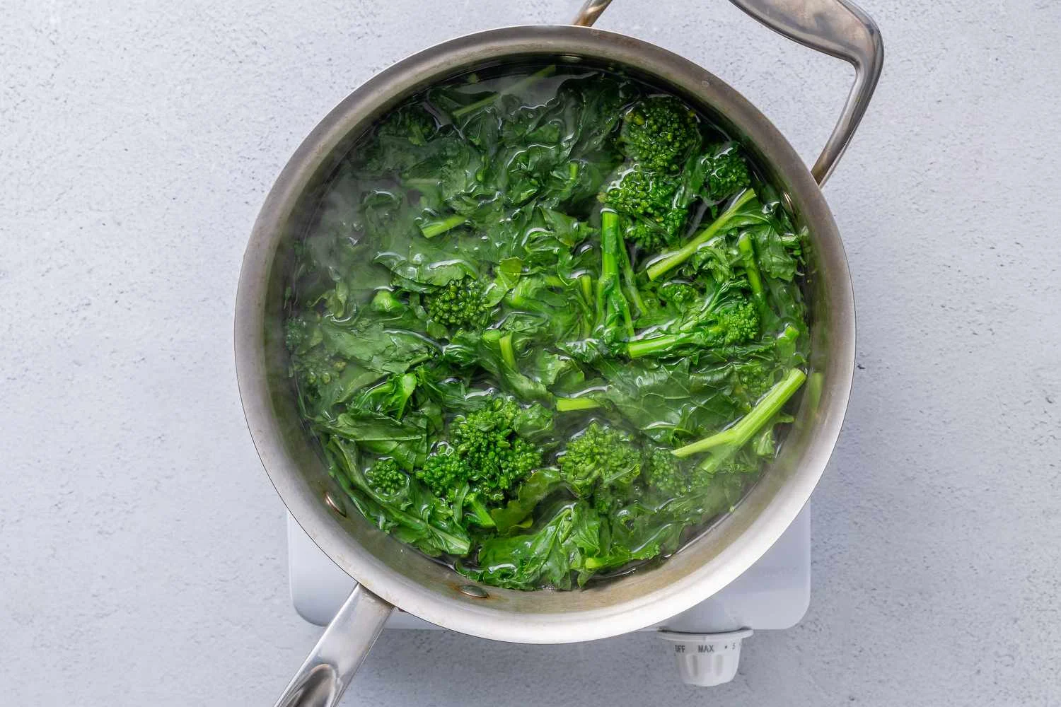 Broccoli rabe cooking in a pot of boiling water