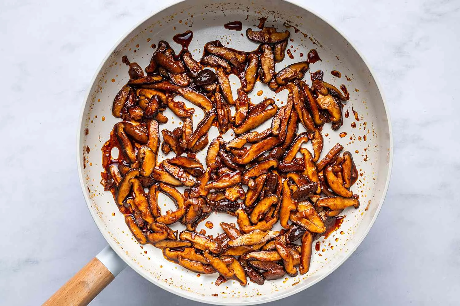A skillet with shiitake mushrooms and shallots cooked in shoyu, paprika, and pepper