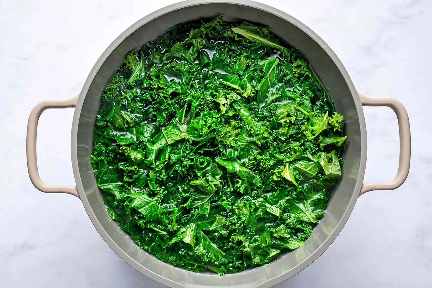 Greens added to the pot of boiling water