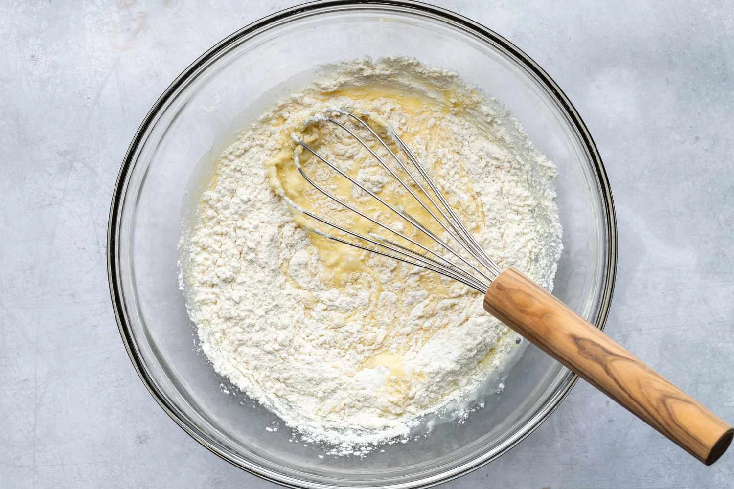 Flour being mixed into the milk-egg mixture