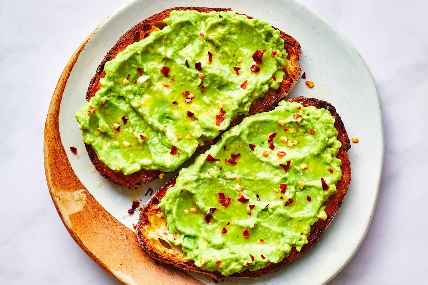 Avocado mash spread on toast with seasoning