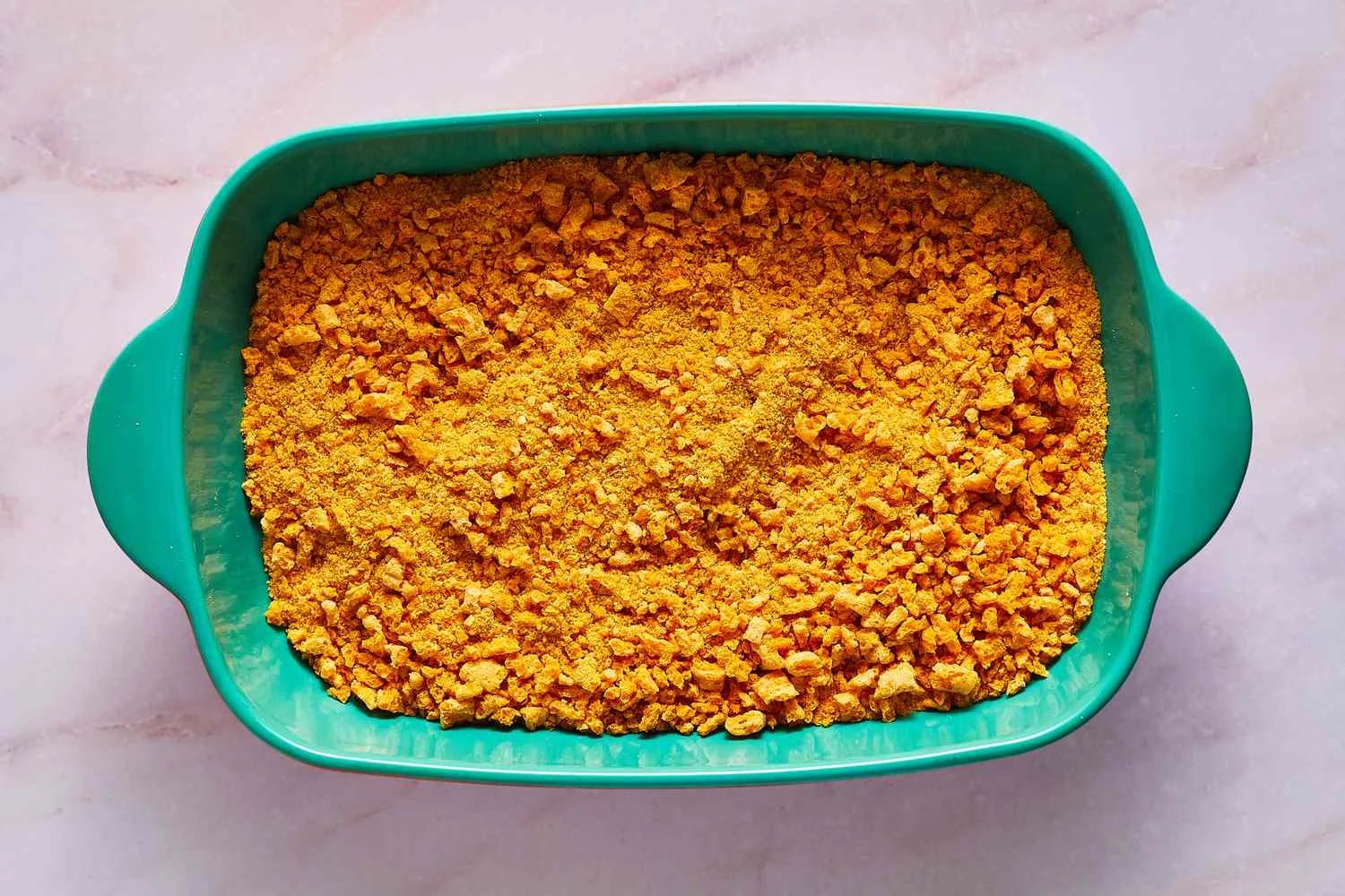 A baking dish filled with crushed Cap'n Crunch cereal