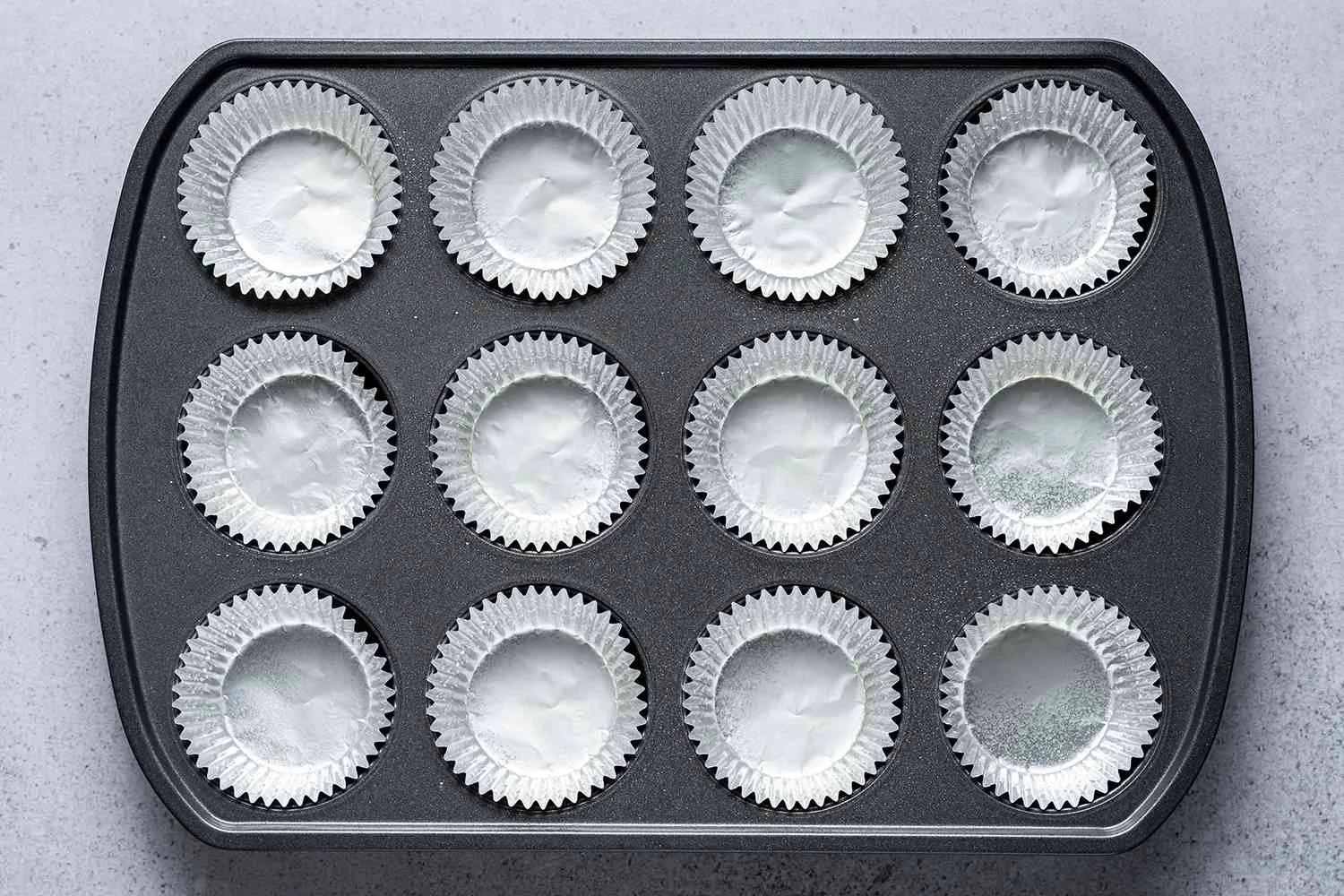 A muffin pan lined with liners