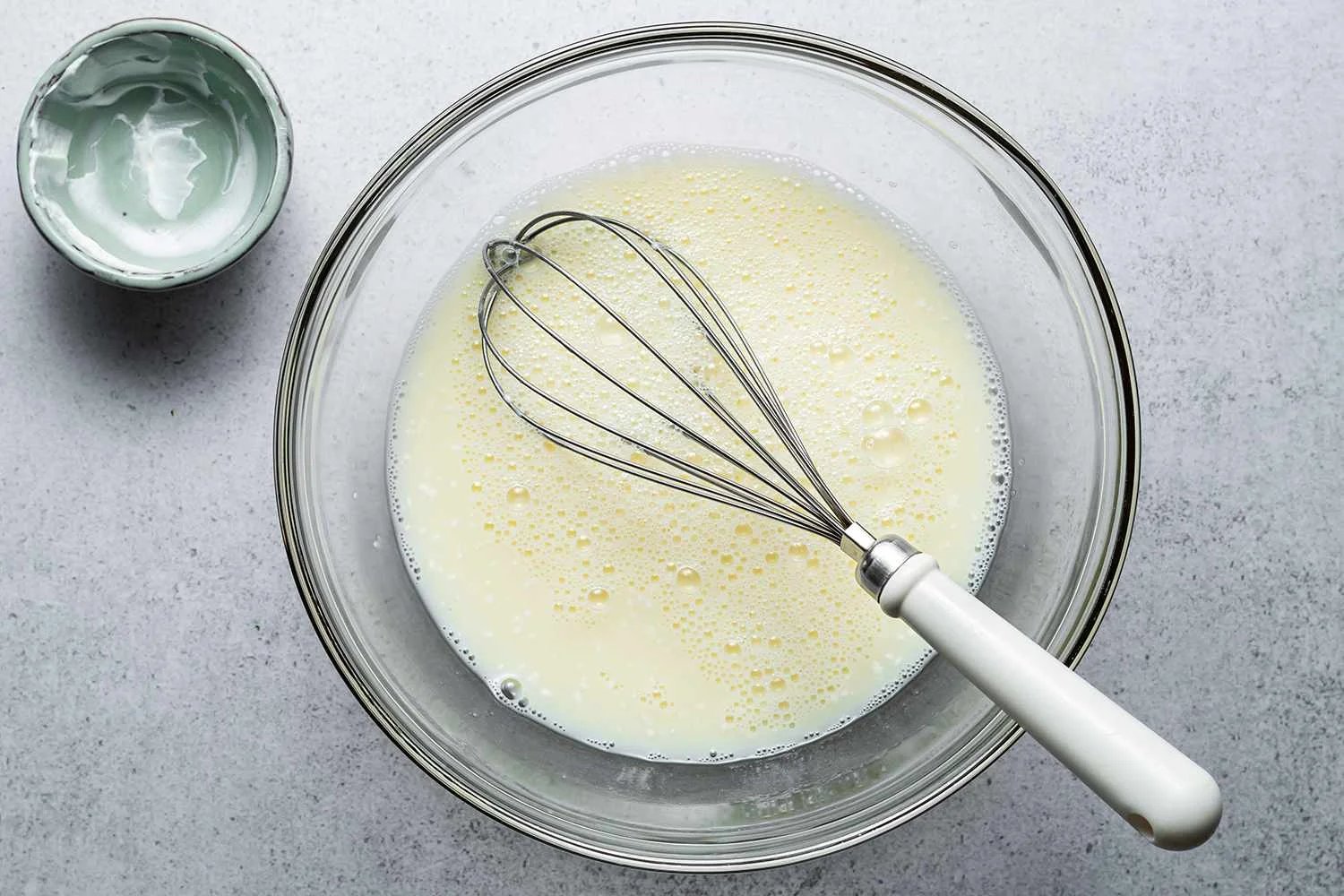 A bowl of egg whites and sour cream mixture