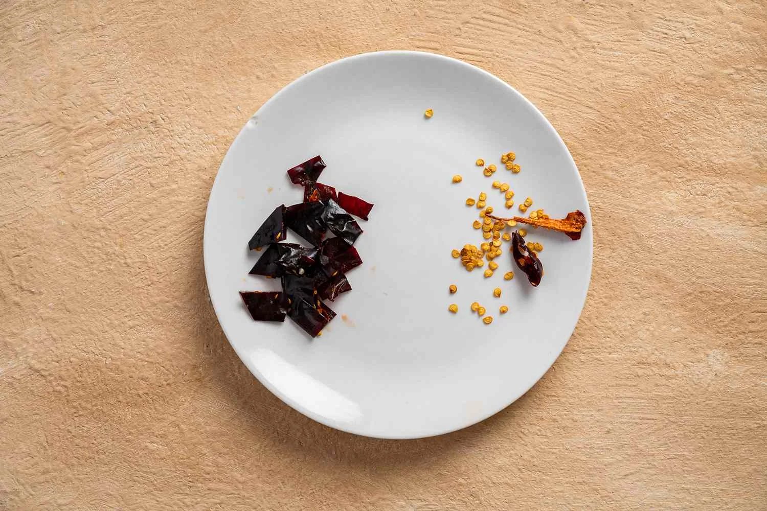 Stem and deseed the guajillo chiles on a plate 