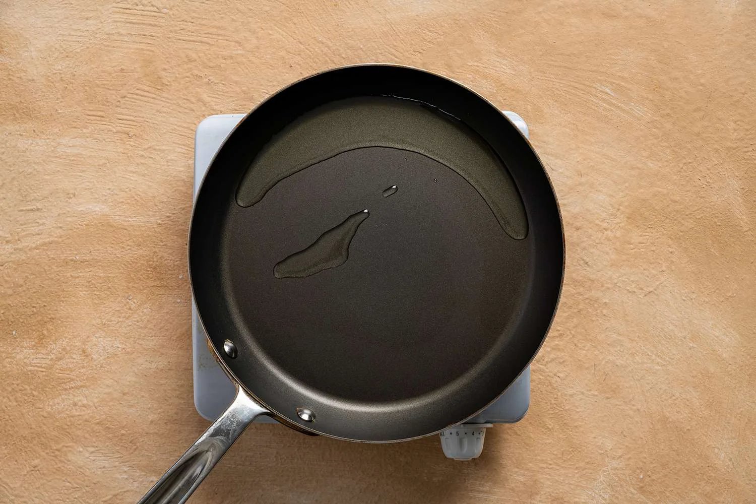 Oil in a pan on a burner 