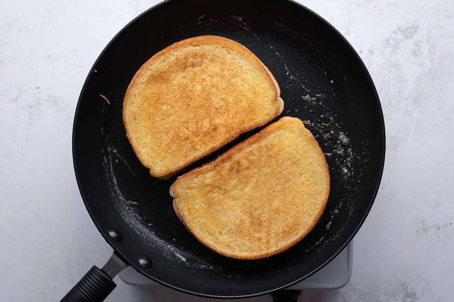 Sandwiches cooking in a nonstick skillet